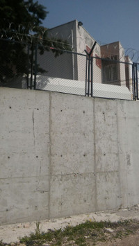 Mauern und Stacheldraht am ehemaligen Wohnheim-Gebäude (Friedensratschlag Hatay)